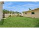 A lovely fenced backyard with green grass, and mature landscaping to be enjoyed year-round at 2804 W Mark Dr, Sarasota, FL 34232