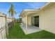 View of a charming backyard with a concrete patio and a sliding door entrance at 2804 W Mark Dr, Sarasota, FL 34232