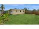 Green backyard with a wooden fence at 2804 W Mark Dr, Sarasota, FL 34232