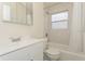 Bright bathroom with a white vanity, a tub/shower combo, and a mirrored medicine cabinet at 2804 W Mark Dr, Sarasota, FL 34232