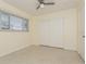 Comfortable bedroom with closet, window providing natural light and neutral decor at 2804 W Mark Dr, Sarasota, FL 34232