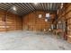 Interior view of garage with shelving, workbenches, and overhead lighting at 2804 W Mark Dr, Sarasota, FL 34232