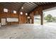 Interior view of garage with shelving, workbenches, and overhead lighting at 2804 W Mark Dr, Sarasota, FL 34232