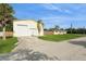View of the spacious detached garage with two bays, a side door, and a well-manicured lawn at 2804 W Mark Dr, Sarasota, FL 34232