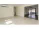 Open concept living room leading to a tiled area and large sliding doors at 2804 W Mark Dr, Sarasota, FL 34232