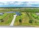 Aerial view of a home with green outdoor space and a large driveway at 3518 Recurve Cir, Sarasota, FL 34240
