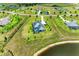 Aerial view of a home with green outdoor space and a small lake nearby at 3518 Recurve Cir, Sarasota, FL 34240
