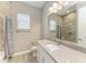 Bright bathroom with granite countertop, single sink, shower, with neutral colors and modern fixtures at 3518 Recurve Cir, Sarasota, FL 34240