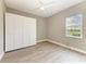 Inviting bedroom with wood-look floors, ceiling fan, recessed lighting, and a large closet for ample storage at 3518 Recurve Cir, Sarasota, FL 34240