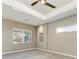 Serene bedroom with tray ceiling, ceiling fan, and natural light, creating a relaxing ambiance at 3518 Recurve Cir, Sarasota, FL 34240