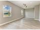 Spacious bedroom with wood-look flooring, ceiling fan, recessed lighting, and two windows for ample natural light at 3518 Recurve Cir, Sarasota, FL 34240