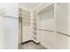 Walk-in closet with custom shelving and drawers, featuring hanging rods, and carpeting at 3518 Recurve Cir, Sarasota, FL 34240