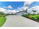 Long driveway leading to a beautiful home, with landscaped grounds and a three-car garage at 3518 Recurve Cir, Sarasota, FL 34240