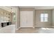 Spacious entryway with modern lighting, double doors, and an adjacent office space at 3518 Recurve Cir, Sarasota, FL 34240