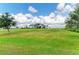 Exterior view of a home with large green outdoor space and blue sky at 3518 Recurve Cir, Sarasota, FL 34240