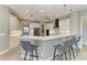 Modern kitchen with sleek bar seating, stainless steel appliances, and contemporary white cabinets at 3518 Recurve Cir, Sarasota, FL 34240