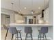 Bright kitchen with white cabinetry, modern pendant lighting, and sleek barstool seating at 3518 Recurve Cir, Sarasota, FL 34240