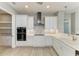 Bright, well-appointed kitchen with white cabinetry, sleek appliances, and modern design at 3518 Recurve Cir, Sarasota, FL 34240