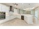 Modern kitchen with stainless appliances, white cabinetry, and decorative backsplash at 3518 Recurve Cir, Sarasota, FL 34240