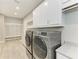 Spacious laundry room features cabinetry, quartz counter, sink, and appliances at 3518 Recurve Cir, Sarasota, FL 34240