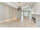 Bright, open-concept living room with light wood floors and a modern fireplace, offering a cozy atmosphere at 3518 Recurve Cir, Sarasota, FL 34240