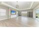 Spacious living room boasts tray ceilings, modern light fixtures, built-in shelving, and sliding glass doors at 3518 Recurve Cir, Sarasota, FL 34240
