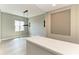 Neutral living room featuring a contemporary light fixture, bright natural light, and inviting space at 3518 Recurve Cir, Sarasota, FL 34240