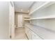 Spacious mudroom with white cabinets, quartz counters, shelving, and bench at 3518 Recurve Cir, Sarasota, FL 34240