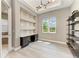 Stylish office features built-in shelves, a desk area, modern lighting, and a large window at 3518 Recurve Cir, Sarasota, FL 34240
