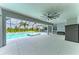 Enclosed pool with an attached spa, ceiling fan, and view of green outdoor space at 3518 Recurve Cir, Sarasota, FL 34240