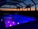 Night view of the illuminated pool and spa with fountain feature at 3518 Recurve Cir, Sarasota, FL 34240