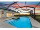 Enclosed pool with an attached spa and view of sunset at 3518 Recurve Cir, Sarasota, FL 34240
