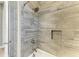 Elegant shower with gray textured tiling, a built-in niche, and updated fixtures for a spa-like experience at 3518 Recurve Cir, Sarasota, FL 34240