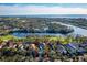 Gorgeous aerial view showcases a home with mature trees near a golf course and waterfront at 3521 Fair Oaks Ln, Longboat Key, FL 34228