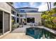 Backyard with pool, lounge furniture, and palm trees at 3521 Fair Oaks Ln, Longboat Key, FL 34228