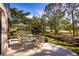 Outdoor seating area with a tranquil garden view and ample space for relaxation and entertaining at 3521 Fair Oaks Ln, Longboat Key, FL 34228