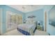 Light blue bedroom with shutters, overhead fan, and nautical decor at 3521 Fair Oaks Ln, Longboat Key, FL 34228