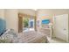 Cozy bedroom with access to the outdoor patio with a pool and spa; modern furniture and fixtures at 3521 Fair Oaks Ln, Longboat Key, FL 34228