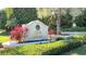 Entrance to Queens Harbour with beautifully landscaped sign and lush tropical plants at 3521 Fair Oaks Ln, Longboat Key, FL 34228