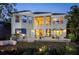 Spacious home exterior with large windows, a patio, and a beautifully landscaped backyard at 3521 Fair Oaks Ln, Longboat Key, FL 34228