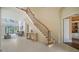 Spacious foyer with elegant staircase and lots of natural light, creating a grand entrance at 3521 Fair Oaks Ln, Longboat Key, FL 34228