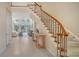Bright foyer features a staircase with wood railing and entry to the living room with floor-to-ceiling windows at 3521 Fair Oaks Ln, Longboat Key, FL 34228