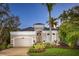 Charming single-Gathering home featuring lush landscaping, brick driveway and a neutral color palette at 3521 Fair Oaks Ln, Longboat Key, FL 34228