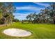 Well-maintained golf course with a sand trap at 3521 Fair Oaks Ln, Longboat Key, FL 34228