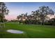Beautiful golf course with trees at 3521 Fair Oaks Ln, Longboat Key, FL 34228