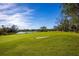 Scenic golf course with pond and blue sky at 3521 Fair Oaks Ln, Longboat Key, FL 34228