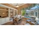 Inviting home office featuring custom built-ins, stylish desk, and a view of the private pool at 3521 Fair Oaks Ln, Longboat Key, FL 34228