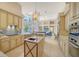Open kitchen with stone countertops, stainless steel appliances, and views of the living room at 3521 Fair Oaks Ln, Longboat Key, FL 34228