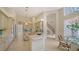 Bright kitchen with center island, tile floors, stainless appliances, and adjacent breakfast nook at 3521 Fair Oaks Ln, Longboat Key, FL 34228