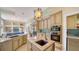 Open kitchen with stone countertops, stainless steel appliances, and views of the living room at 3521 Fair Oaks Ln, Longboat Key, FL 34228
